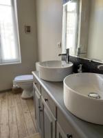 a bathroom with two sinks and a toilet at Le Taurillou 