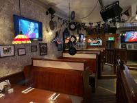 a restaurant with a table and a tv on the wall at The White Hart Hotel in Holsworthy