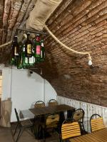 a room with a table with bottles on the ceiling at Pension Old City in Braşov