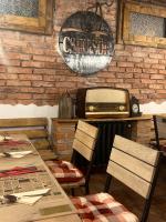 a restaurant with a table and a toaster on a brick wall at Pension Old City in Braşov