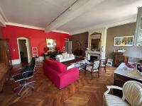 a living room with red walls and a pink couch at Les 24 colonnes in Lyon