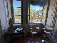 a room with two chairs and two windows at Les 24 colonnes in Lyon