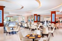 a restaurant with tables and chairs in a building at Pickalbatros Royal Moderna Sharm "Aqua Park"- All inclusive in Sharm El Sheikh