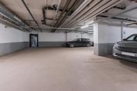 a parking garage with two cars parked in it at Courtyard by Marriott Stockholm Kungsholmen in Stockholm