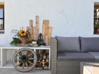 a table with a wooden wheel and a couch at Apartment Appartment Wiesberg by Interhome in Niedernsill