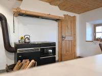 a kitchen with a stove and a door at Apartment Appartment Wiesberg by Interhome in Niedernsill