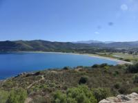 a view of a lake with mountains in the background at Holiday Home Chez Béatrice et Pascal by Interhome in Belgodère