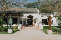 duas estátuas de mulheres em frente a um edifício em Blaauwklippen Manor by NEWMARK em Stellenbosch