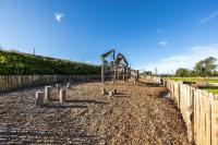 a playground in a park with a wooden fence at DOMAINE SAÂNE ET MER in Quiberville