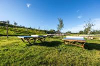 a group of picnic tables sitting in the grass at DOMAINE SAÂNE ET MER in Quiberville