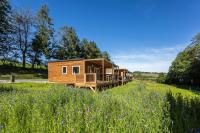 a wooden cabin in a field of flowers at DOMAINE SAÂNE ET MER in Quiberville