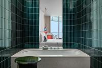 a bathroom with a tub and a couch in a room at W Dubai - Mina Seyahi in Dubai