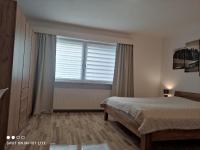 a bedroom with a bed and a large window at groassehof Haus Gstrein in Imsterberg