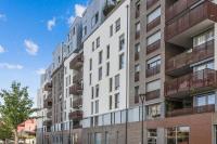 an exterior view of a tall apartment building at Comfortable flat w views of Paris in Saint-Denis - Welkeys in Saint-Denis