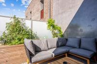 a blue couch sitting on a wooden deck at Comfortable flat w views of Paris in Saint-Denis - Welkeys in Saint-Denis