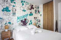 a bedroom with a bed with a wall covered in stickers at Comfortable flat w views of Paris in Saint-Denis - Welkeys in Saint-Denis