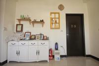 a room with a white cabinet and a black door at Happy Tree Hostel in Jinning