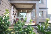 a front door of a house with plants at Happy Tree Hostel in Jinning