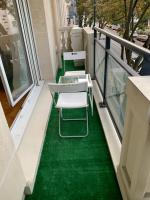 a balcony with green flooring on a building at Lieu de ressourcement à Robinson in Le Plessis-Robinson