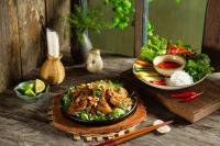 una mesa con un plato de comida y un tazón de sopa en Awesome Hanoi Hostel, en Hanói