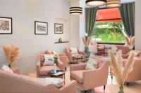 a waiting room with pink furniture and a large window at Best Western Plus Hôtel Brice Garden Nice in Nice