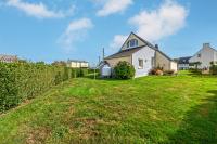 a house in a yard with a green lawn at Meublé De Tourisme Acanthe in Camaret-sur-Mer