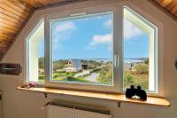 a window with two cats sitting on a shelf at Meublé De Tourisme Acanthe in Camaret-sur-Mer