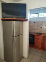 a kitchen with a stainless steel refrigerator and a stove at Appartement d&#39;une chambre avec jardin clos et wifi a Le Lamentin in Le Lamentin