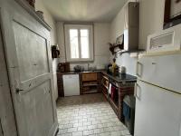 a kitchen with a white refrigerator and a window at GITE AU COEUR DU VIGNOBLE ALSACIEN in Ribeauvillé
