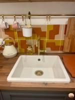 a kitchen counter with a white sink in a kitchen at Studio Calme Batignolles in Paris