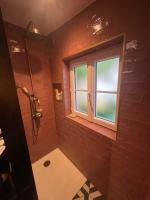 a bathroom with a shower and a window at Studio Calme Batignolles in Paris