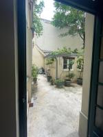 an open door to a courtyard with potted plants at Studio Calme Batignolles in Paris