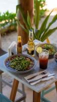 a table with a plate of food and drinks on it at Totem Beach Club - Celestun in Celestún