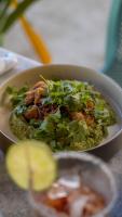 a bowl of food on a table with a salad at Totem Beach Club - Celestun in Celestún
