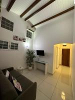 a living room with a couch and a tv at Appartement Coeur de Papillon in Baie-Mahault