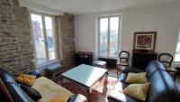 a living room with a couch and a table at le panoramique in Quimper
