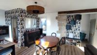 a dining room with a table and a stone wall at le panoramique in Quimper