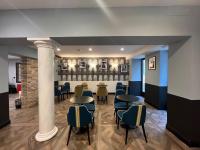 a lobby with tables and chairs in a building at Hotel Do Pozzi in Venice