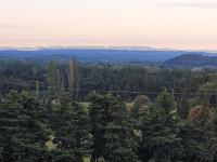 an aerial view of a forest with mountains in the distance at Mas du Tilleul in Beaumes-de-Venise