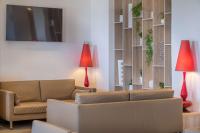 a living room with a couch and two red lamps at Best Western Premier Hotel Prince de Galles in Menton