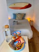 a table with two bags of chips and a glass of water at Little California - Adorable Studio Indépendant in Cagnes-sur-Mer