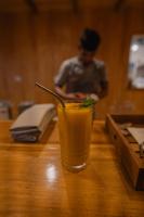 a drink sitting on top of a wooden table at Reserva Natural Iguazú - Pristine Luxury Camp in Puerto Libertad