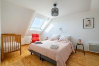 a bedroom with a large bed in a attic at Ar Mimoza - Appt pour 6 in Muzillac