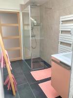 a bathroom with a shower with a glass door at Manava Villa vue mer et Mont Saint Michel piscine intérieure in Saint-Jean-le-Thomas