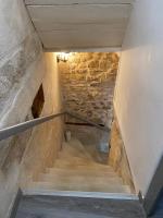 a staircase in a building with a stone wall at Bienvenue au 6 - Calme et charme de la pierre. in Fourques
