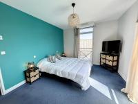 a blue bedroom with a bed and a flat screen tv at Appartement Saint-Pair-sur-Mer, 3 pièces, 4 personnes - FR-1-361-506 in Saint-Pair-sur-Mer