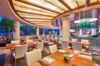 a restaurant with wooden tables and chairs and a large ceiling at Sheraton Zhoushan Hotel in Zhoushan