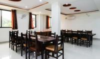 een eetkamer met een houten tafel en stoelen bij Meera Valley Resort By Nexottel in Udaipur