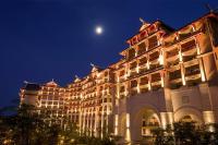 a large building at night with a moon in the sky at Haikou Marriott Hotel in Haikou