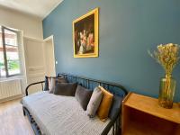 a bedroom with blue walls and a bed with pillows at Le LOUIS 16 - Maison avec jardin in Valence